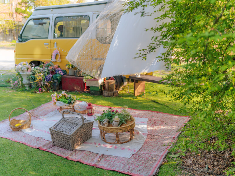 picnic set up with picnic baskets and flowers